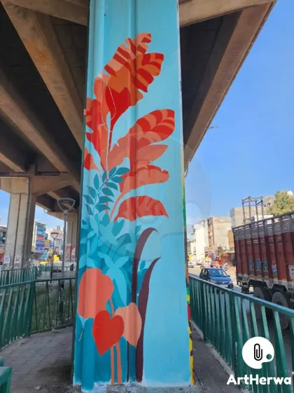 This pillar features a vibrant design of abstract red and orange leaves against a cool blue background, adding a splash of color to the roadside.