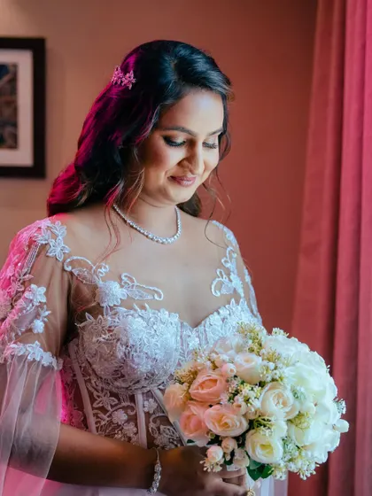 A beautiful portrait with soft, rosy lighting. The bride's makeup features warm tones that make her look absolutely divine.