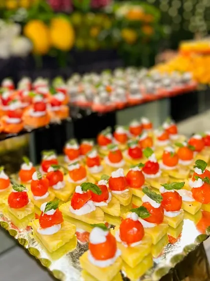These colorful fruit skewers feature pineapple, cherry tomatoes, and fresh cream, making for a healthy, sweet, and refreshing dessert.