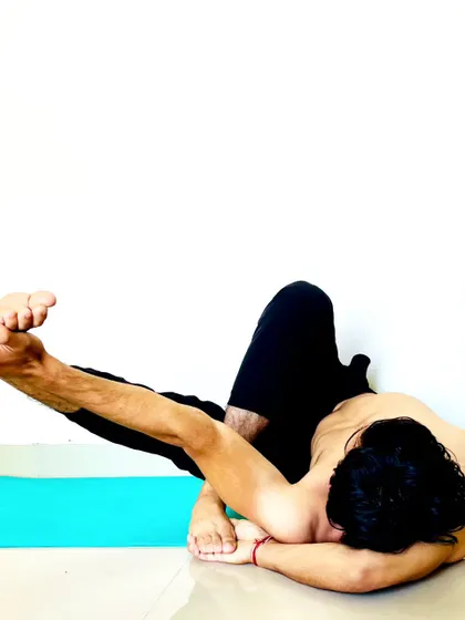 An advanced twisting and balancing pose that requires deep hip opening and spinal flexibility.