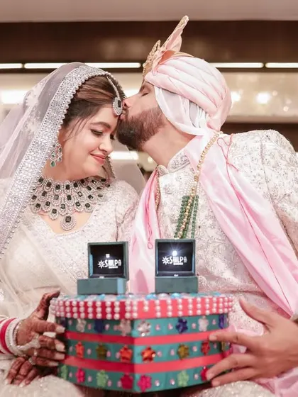 A sweet forehead kiss after the ceremonies are complete. This shot captures the love and relief, with their beautiful ring boxes on display.