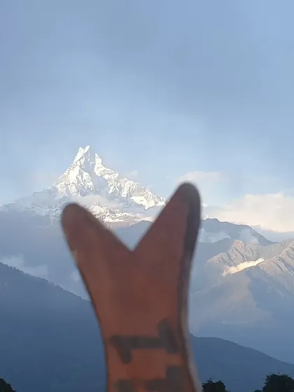 A creative shot of the fishtail mountain, Machapuchare, framed by a piece of local art.