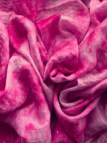A vibrant pink Tabby Silk Tie-Dye fabric, perfect for creating outfits that are boho, breezy, and beyond beautiful.
