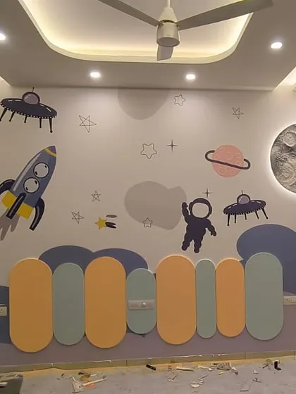 For this kids' bedroom, I combined a 3D moon mural with playful, painted rockets and astronauts. The moon itself is textured and lights up, making it an interactive and magical element in the room's space theme.