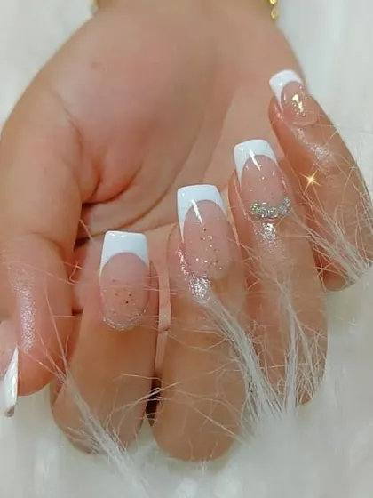 Another shot of the glittery French manicure, showing the clean lines and precise application.