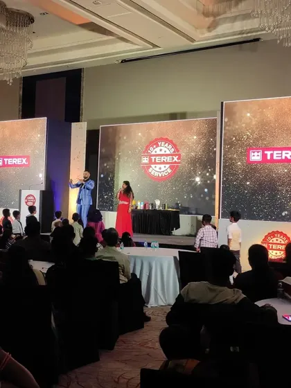 Audience participation is key to a memorable event. Here, I'm guiding volunteers through a magical routine on the Terex stage.