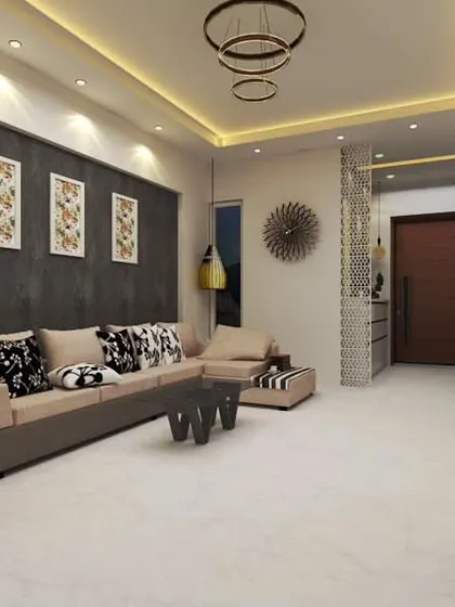 We designed this living area with a dark textured accent wall and a comfortable L-shaped sofa. A decorative jaali partition provides partial separation while allowing light and views to filter through, adding an element of intricate detail.