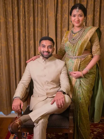 A full view of this stunning couple. The coordinated outfits and happy smiles make for a truly special moment.