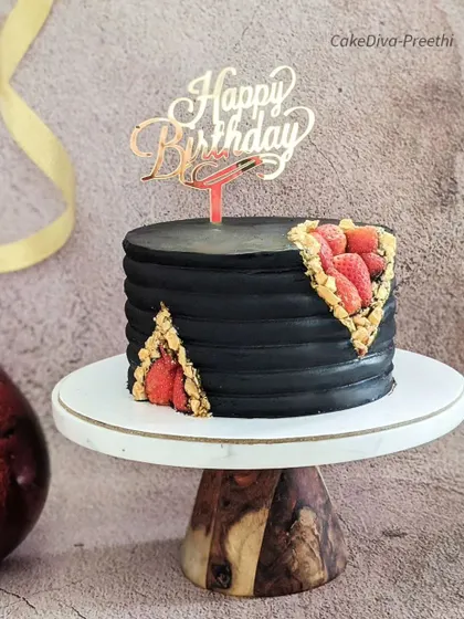 My take on a geode cake, but with a twist. Instead of rock candy, the cavity of this black frosted cake is filled with fresh strawberries, creating a beautiful and delicious contrast.