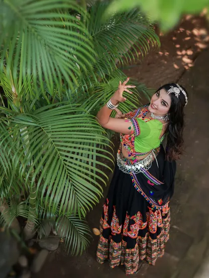 A vibrant and energetic series celebrating Navratri. The model is dressed in colorful Garba attire, and the photos capture the festive spirit through dynamic poses and joyful expressions.