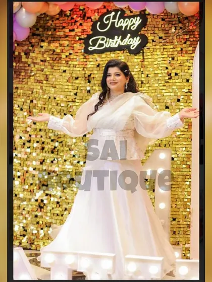 A full view of the beautiful white organza gown with a peplum jacket. This outfit is perfect for a birthday celebration or a daytime wedding event.