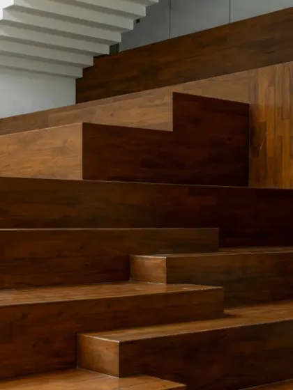 A detail shot of the wooden staircase seating at the Sona Library, featured for its role in bringing back the joy of reading. The design blends natural light and local materials to create a space where knowledge meets calm.
