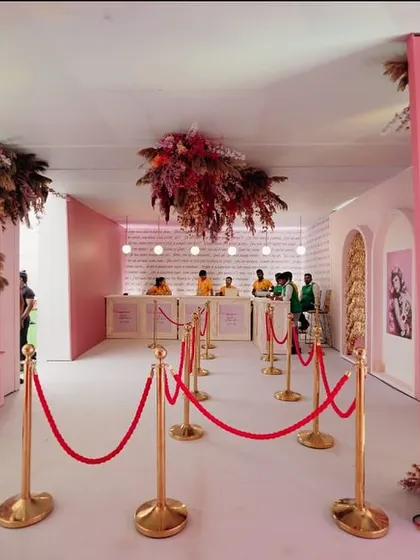 The registration area for the "Fireworks" event was designed to be an experience in itself, with floral clouds hanging from the ceiling and artfully arranged niches.