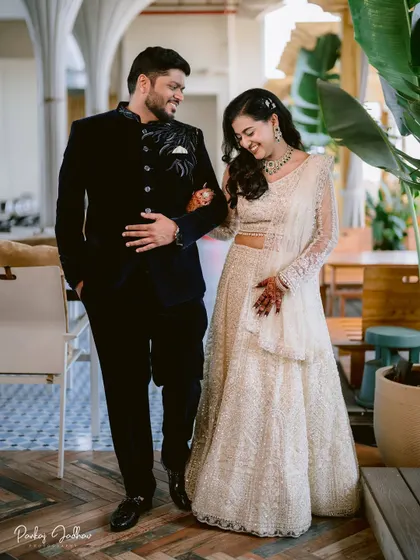 Walking together into their future. This candid shot of Swati and Sarthak at their engagement captures a natural, happy moment between the couple.