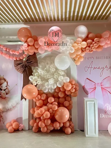 Another angle of the elaborate bow-themed backdrop, showcasing the depth and volume of the balloon arrangement.