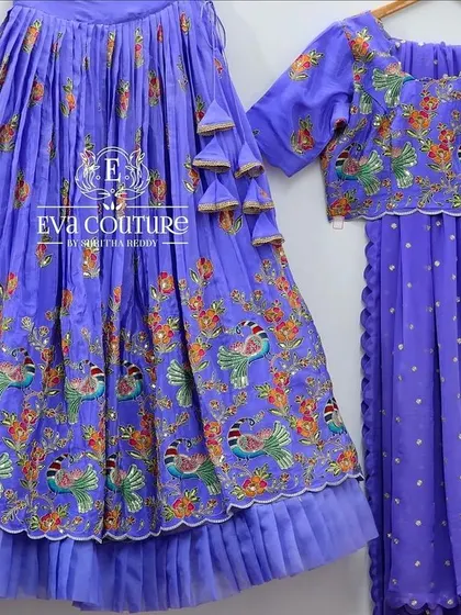 A lavender version of the Paithani-style embroidered lehenga. The intricate, colorful embroidery mimics the look of a woven Paithani border.
