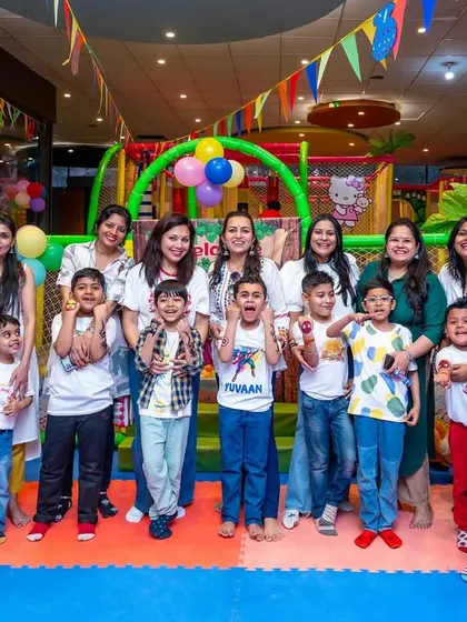 A happy group photo of kids and moms in the play area. It's a space designed for the whole family to enjoy and make memories together.