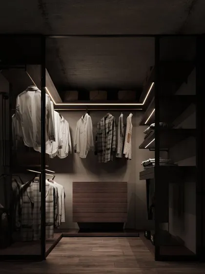 A walk-in closet designed with a moody, sophisticated palette. We used smoked glass doors, dark wood, and integrated LED strip lighting to create a space that feels like a personal boutique, where every item is beautifully displayed.
