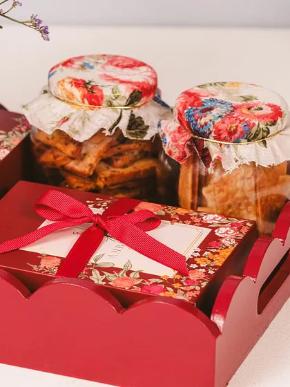Illuminate your celebrations with our Imperial Diwali Hampers. This small Imperial Tray is filled with jars of cookies and a box of our finest sweets, tied with a red ribbon.