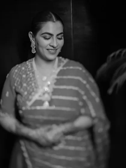 A beautiful, candid black and white portrait of the bride, Aashrita, during her Mehendi. This shot captures her serene happiness and timeless elegance.