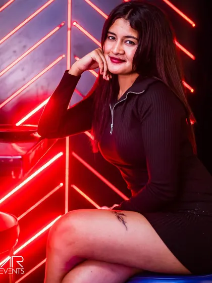 A guest posing against the red neon lights.