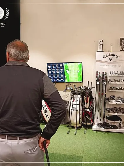 The moment of truth. A client reviews his performance data on the monitor, seeing exactly where his shots are landing and the metrics behind each swing.