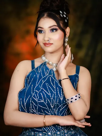 A confident pose that highlights the overall glamour of the look, from the hair to the makeup and accessories.