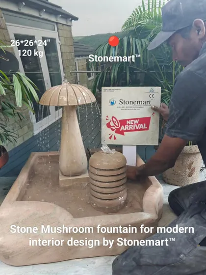 An artisan with the 120 kg stone mushroom fountain, showing its scale. This piece is designed for modern interior and exterior spaces.