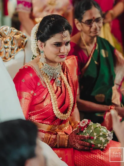 A candid shot of the bride during her wedding ceremony, her expression a mix of focus and happiness.
