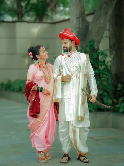 A candid moment as the couple walks together after their ceremony. The natural interaction and smiles make this a lovely, storytelling image.