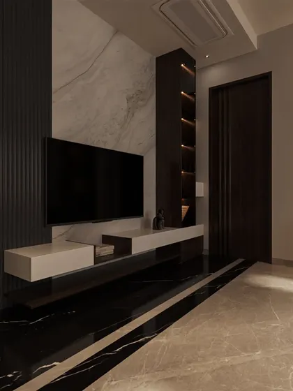 The TV wall features a dramatic combination of black marble flooring, a white marble accent wall, and dark fluted paneling, showcasing a masterful play of materials.