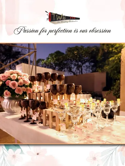 An elegant display of glassware for a Sangeet, including unique dark-hued wine glasses, ready for our signature mocktails.
