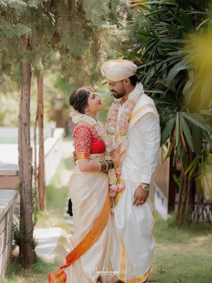 A full-length portrait of the couple looking at each other. This shot captures their beautiful outfits and the loving connection between them.
