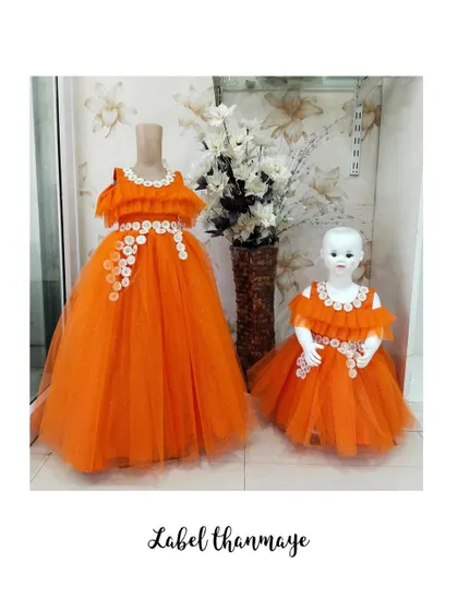 The orange gown and frock set, ready for a client. The color is so vibrant and cheerful.