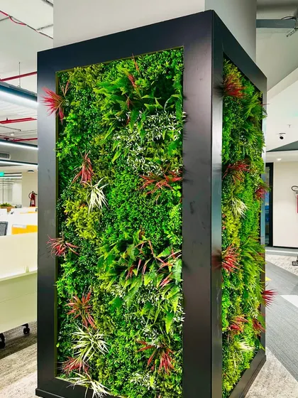 The artificial green wall provides a beautiful backdrop from every angle, breaking up the monotony of the corporate office space.