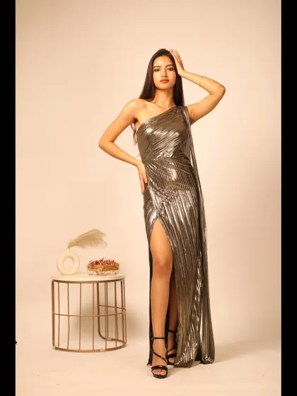 A full-length shot that shows the dramatic slit and the flowing fabric of the gown.