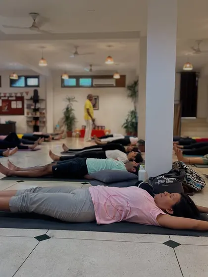 This is the result of a well-guided session: a room full of people in Savasana, experiencing deep, collective rest. This final relaxation pose is essential for integrating the benefits of the practice and leaving participants feeling truly restored.