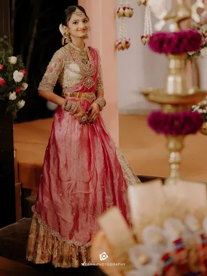 This young client looks poised and elegant in her custom half saree. The beautiful design and rich colors make it a perfect choice for her special day.