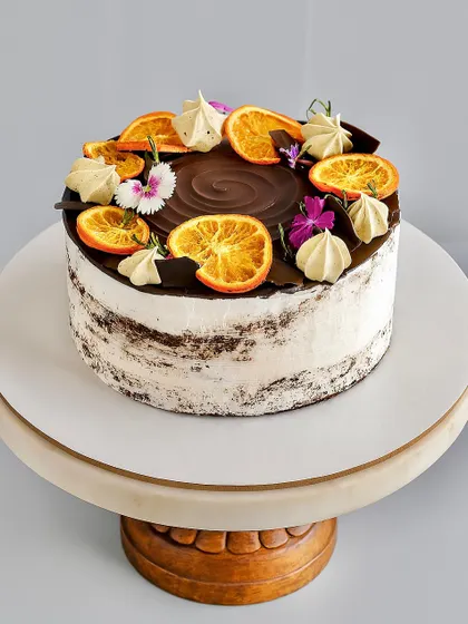 (Hero Media) This Chocolate Orange Naked Cake is one of my absolute favorites to make. It features a soft chocolate sponge, a rich orange-infused dark chocolate ganache, and just a light touch of whipped cream. The candied oranges and fresh flowers make it a beautiful centerpiece for any occasion.