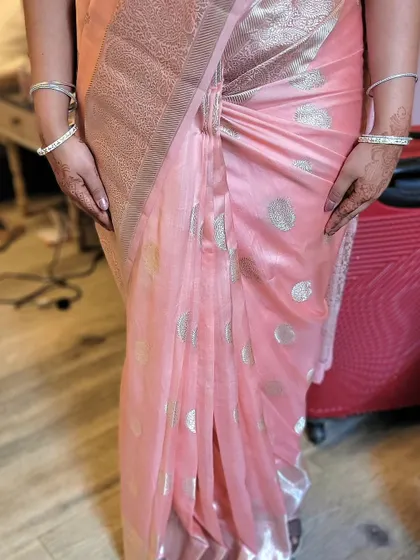 A close-up of the hip pleats on the soft silk saree. This technique gives a beautiful, fitted look around the waist.