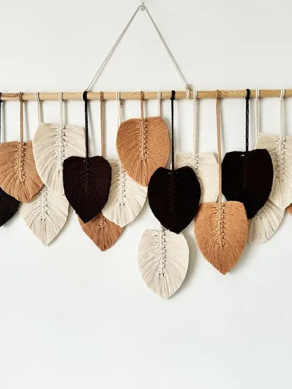 A full shot of the custom feather wall hanging, ready to bring handmade charm to a new home.