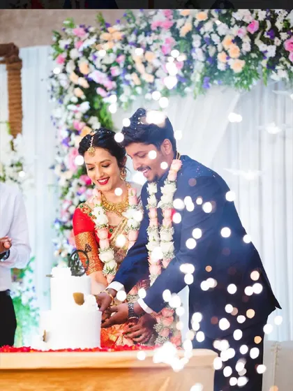 A magical shot of a couple cutting their engagement cake, with sparklers and lights adding to the celebratory moment.