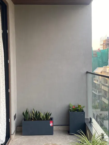 The "before" shot of a balcony corner. This image shows the plain, empty space before I added planters to create a touch of green.