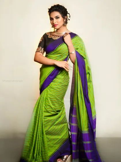 A three-quarter view, showing the beautiful drape of the saree's pallu.
