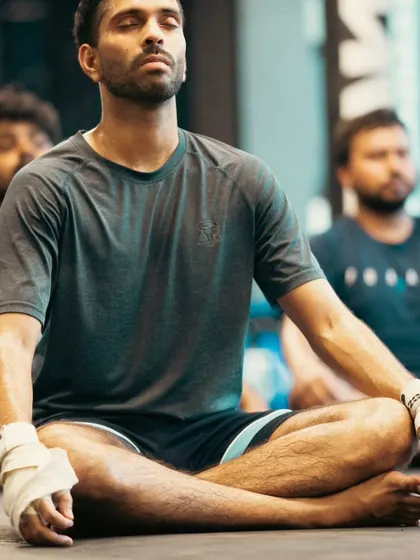 A close-up on a moment of calm. After a tough session, we practice meditation to sharpen the mind and recover.