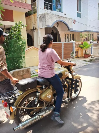 A student practices moving the bike with the engine off. This helps build a feel for the machine's balance and weight in a completely safe setting.
