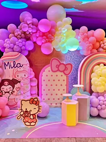 A dreamy Hello Kitty themed birthday party for baby Mila. This setup uses a soft pastel color palette, with adorable character cutouts, a rainbow prop, and extensive balloon decorations to create a whimsical and sweet wonderland.