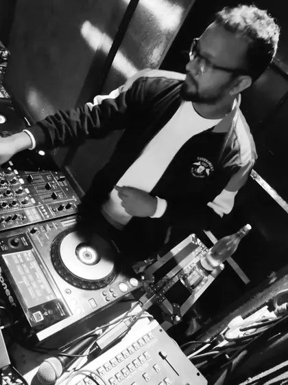 A classic black and white photo of me mixing on the decks, capturing a timeless moment of a DJ at work.