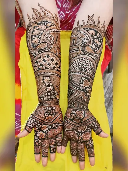 This design is filled with movement, featuring swirling patterns, peacock figures, and a variety of floral and geometric fillers for a rich, textured look.