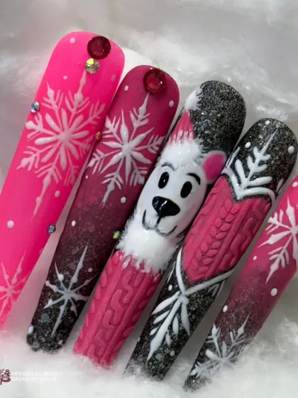 A festive and fun winter-themed set of nail tips, featuring a cute polar bear, snowflakes, and a cozy sweater texture in a bright pink and black color scheme.
